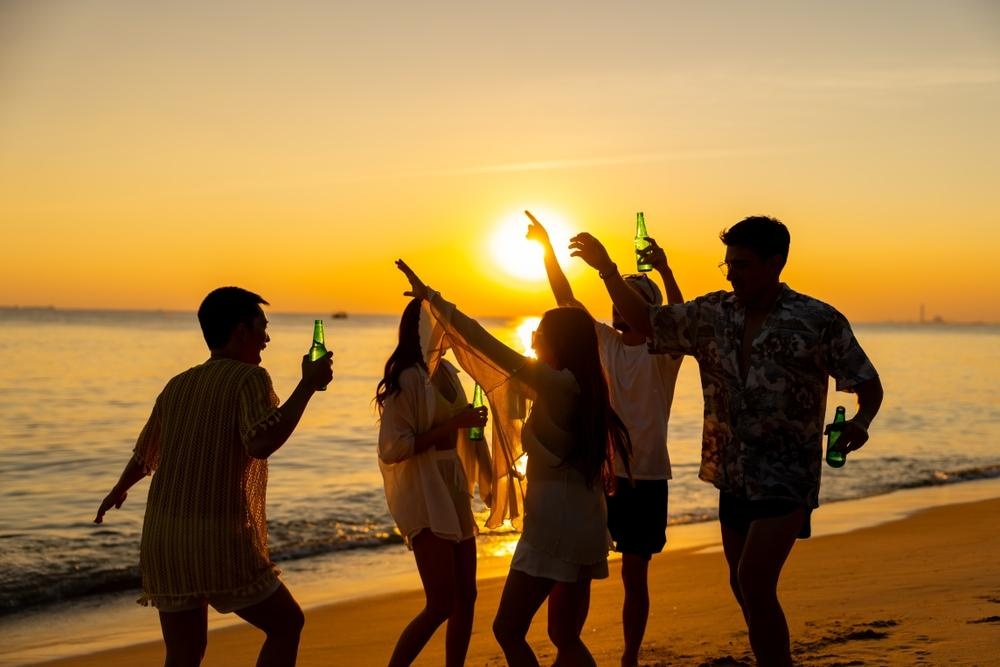 A group of friends enjoying a Phuket beach during sunset