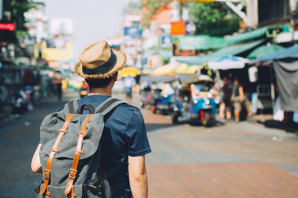 A tourist exploring local streets with a backpack