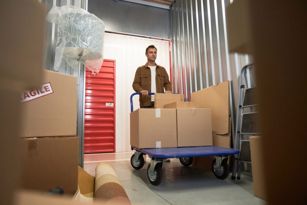 An expat placing boxes into a self storage unit
